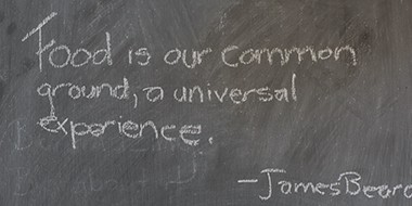 Chalkboard saying Food is our common ground, a universal experience. -James Beard.