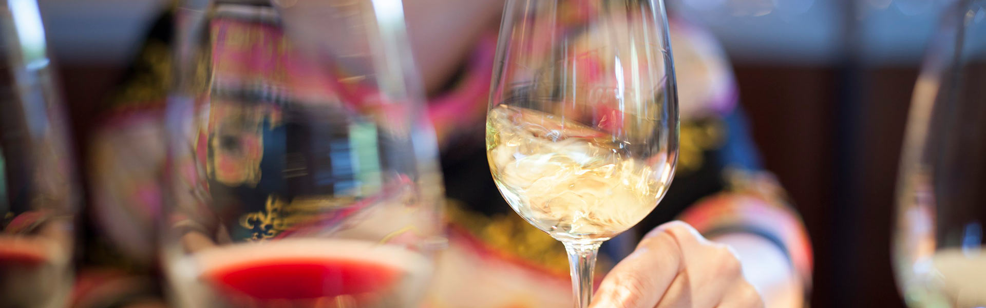 Close up of wine glasses filled with wine.