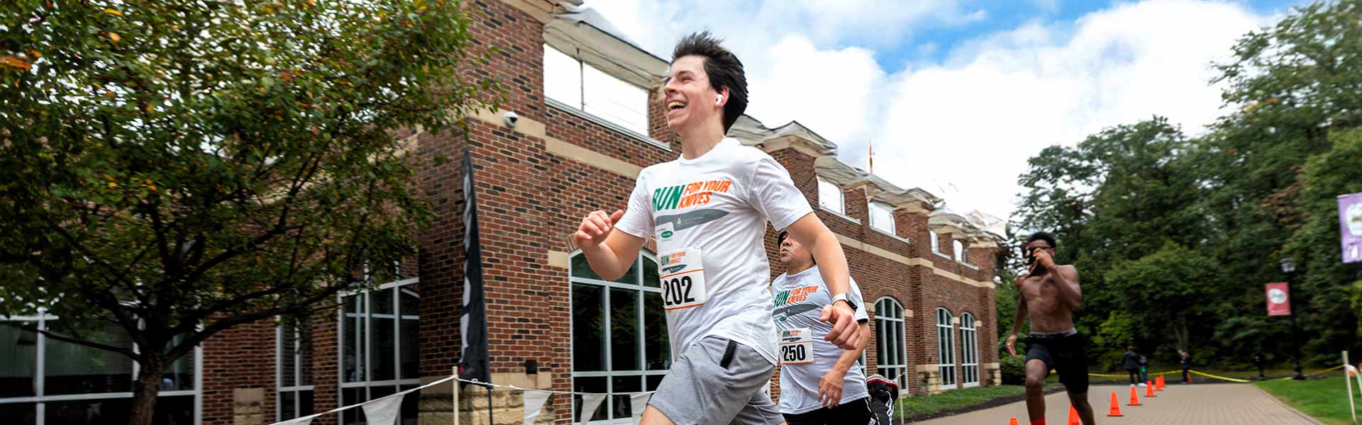 CIA students compete in Run for Your Knives 5K race during Alumni weekend.