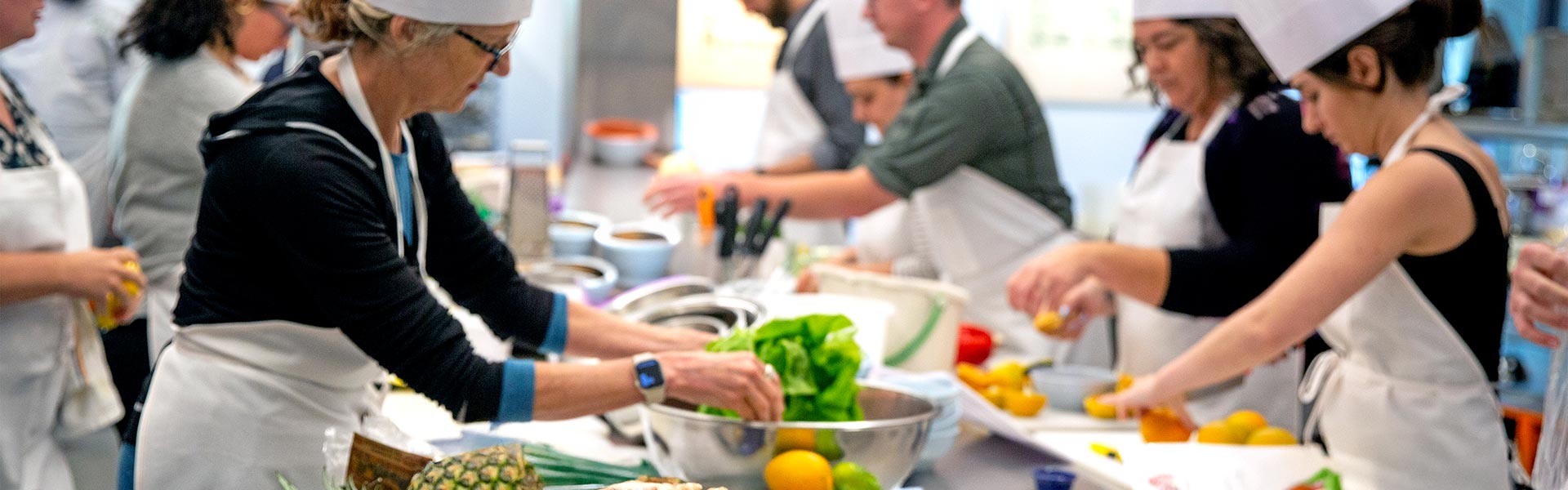 Chefs picking out ingredients in a kitchen.