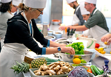 Chefs picking out ingredients in a kitchen.