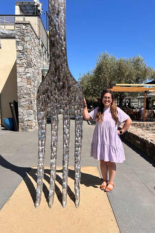 Image of Rebecca Rein, Graduate Admissions and Enrollment Counselor standing next to the CIA at Copia fork.