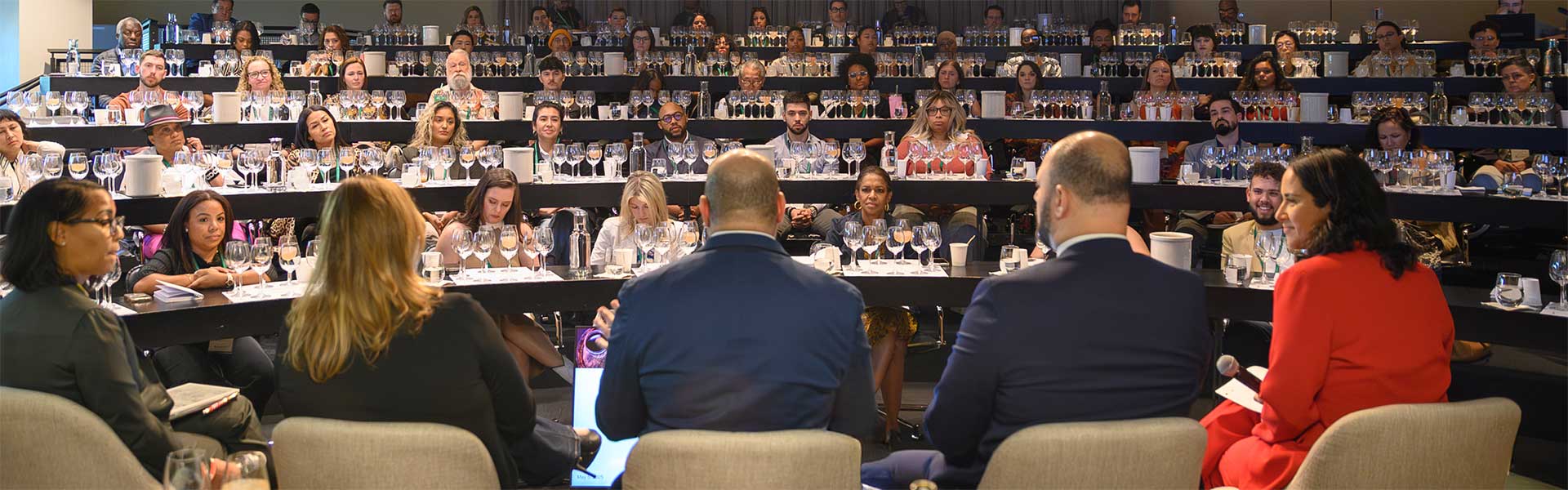 Image of panelists sitting in front of a CIA master’s wine tasting class.